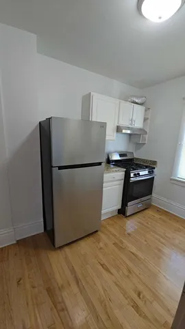 a kitchen with a refrigerator and a sink