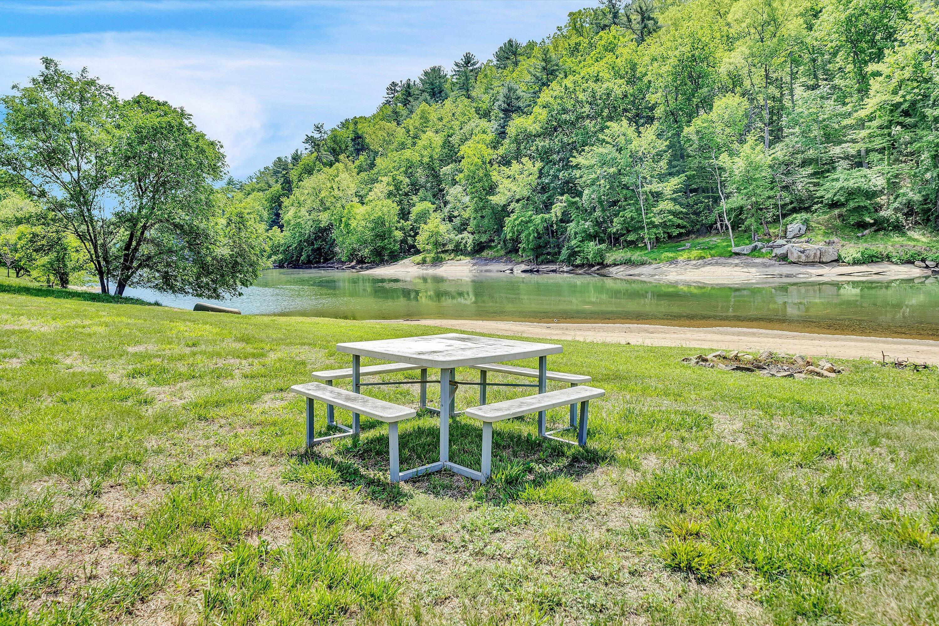 Lot 27 River Rock Road Vinton, VA 24179 - Photo 26 of 28 a view of a lake with a yard and a large tree