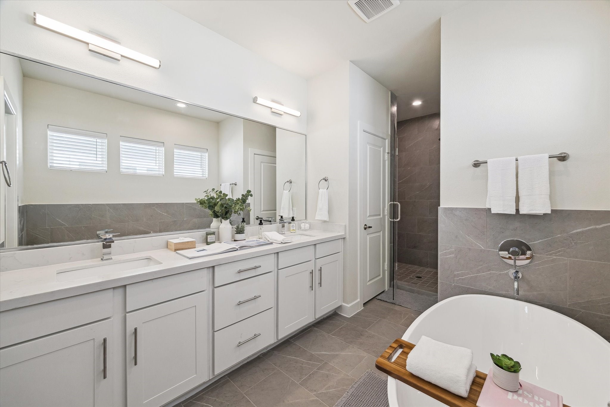 10616 Cascade Ledge Lane Houston, TX 77025 - Photo 12 of 20 The primary bath features a freestanding soaking tub, double vanity, and a sleek glass-enclosed shower.