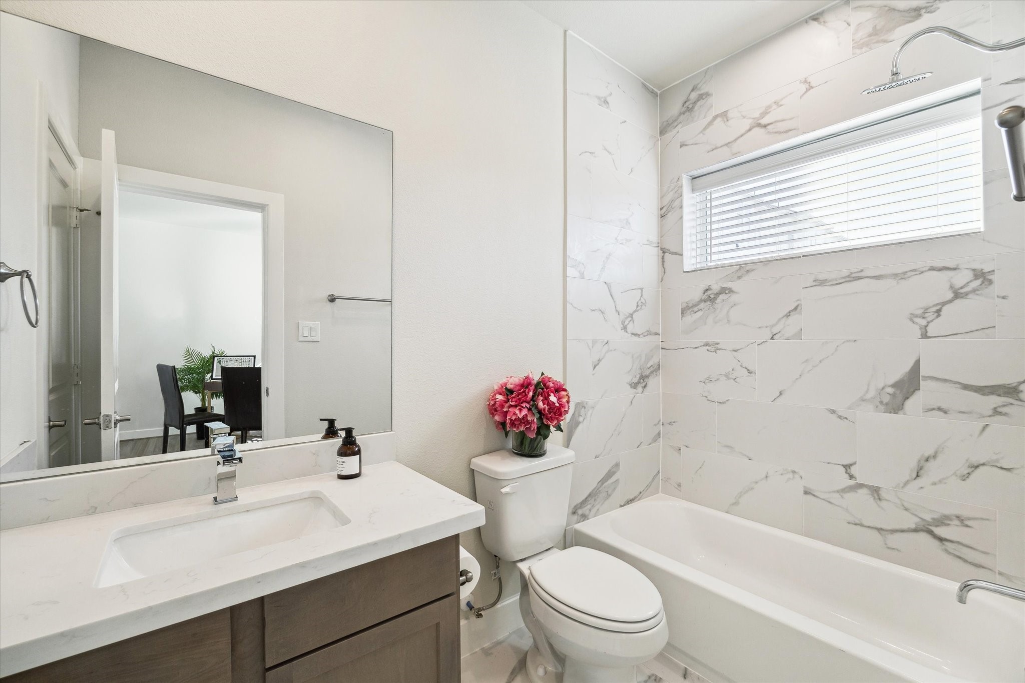 10616 Cascade Ledge Lane Houston, TX 77025 - Photo 16 of 20 A modern guest bath features a clean vanity and stylish tile surround for a polished look.