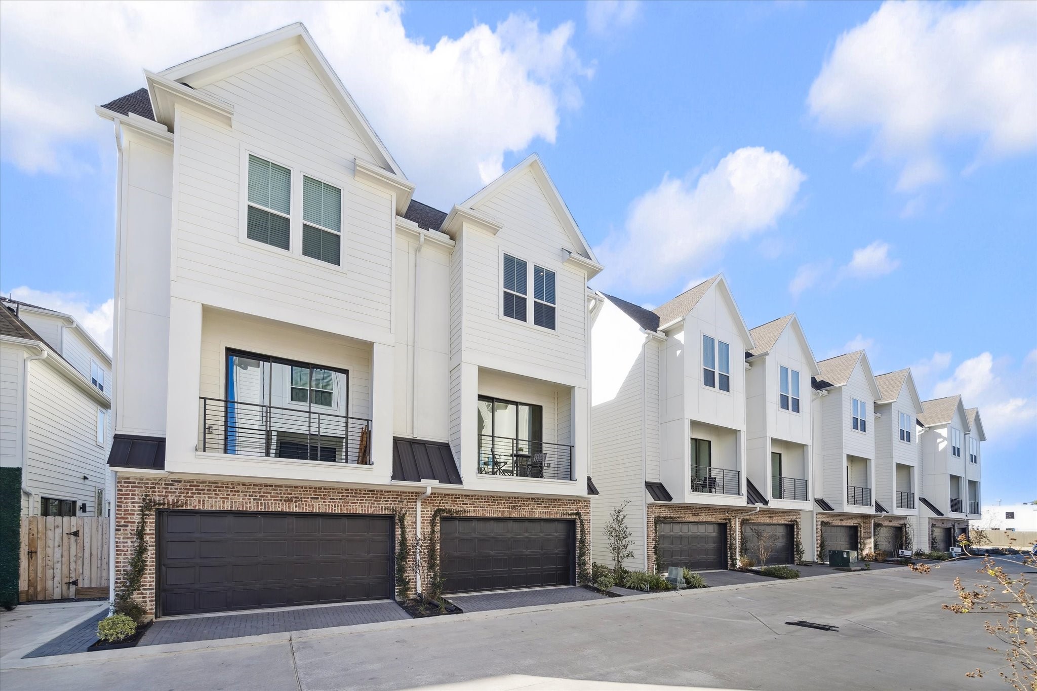10616 Cascade Ledge Lane Houston, TX 77025 - Photo 20 of 20 A row of modern farmhouse-style homes creates a clean, cohesive streetscape in a gated private community, minutes from The Medical Center