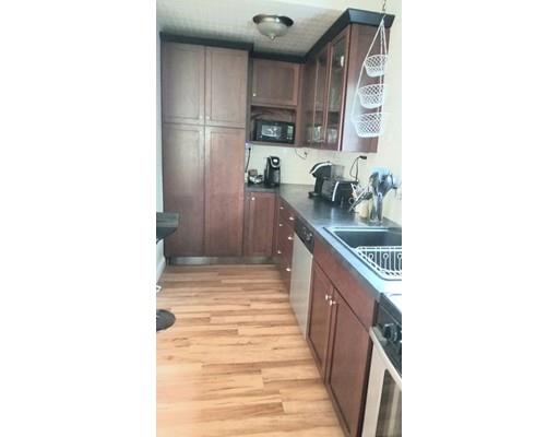 27 Mountainview Street Springfield, MA 01108 - Photo 5 of 20 a kitchen with stainless steel appliances granite countertop a sink and cabinets