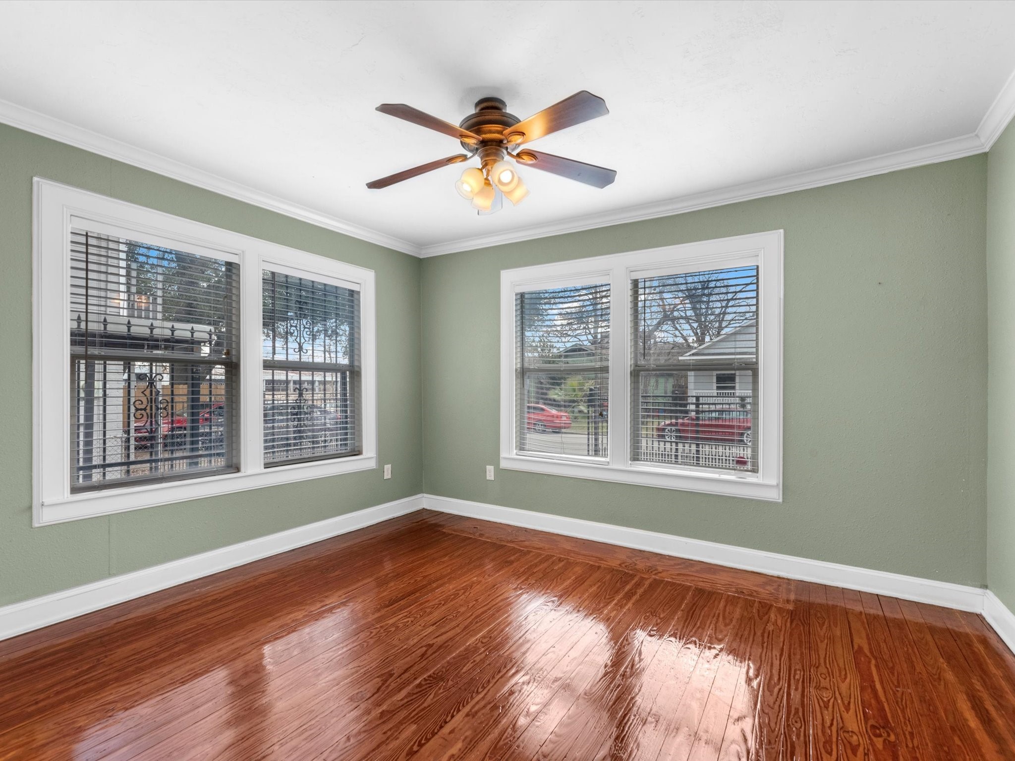 1211 Bigelow Street Houston, TX 77009 - Photo 12 of 18 a view of a livingroom with wooden floor and a ceiling fan