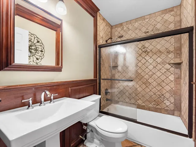 a bathroom with a sink toilet and shower