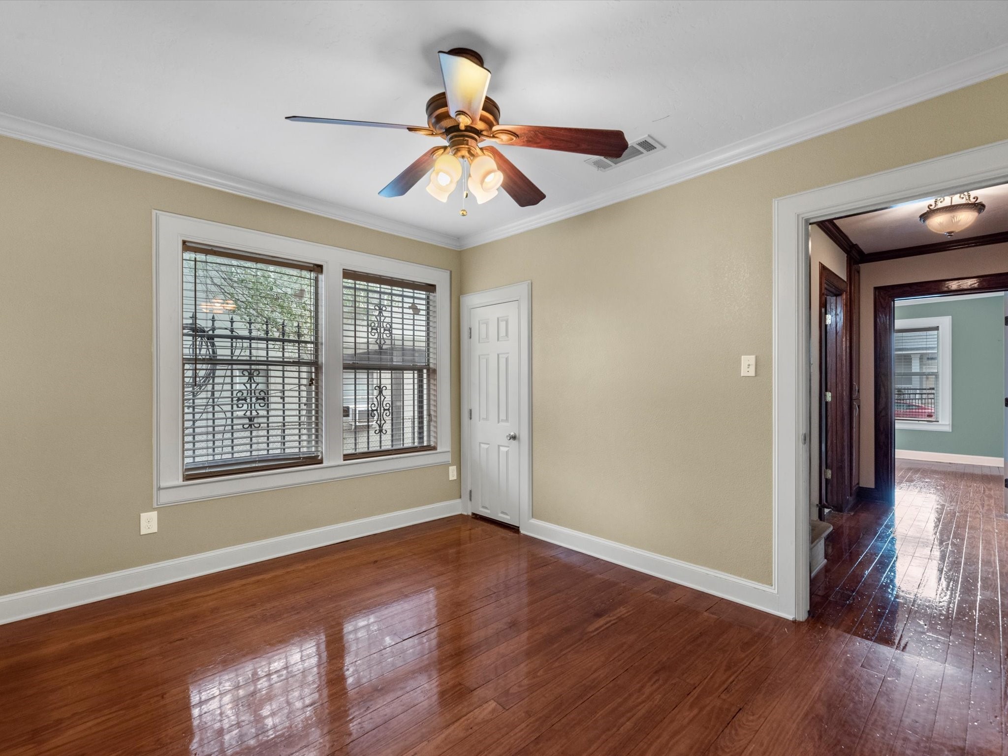 1211 Bigelow Street Houston, TX 77009 - Photo 14 of 18 a view of an empty room with wooden floor and a window