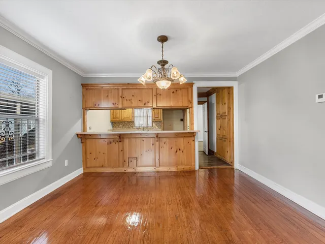 a room with wooden floors and window