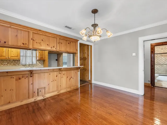 a view of a kitchen with a dishwasher cabinets and wooden floor
