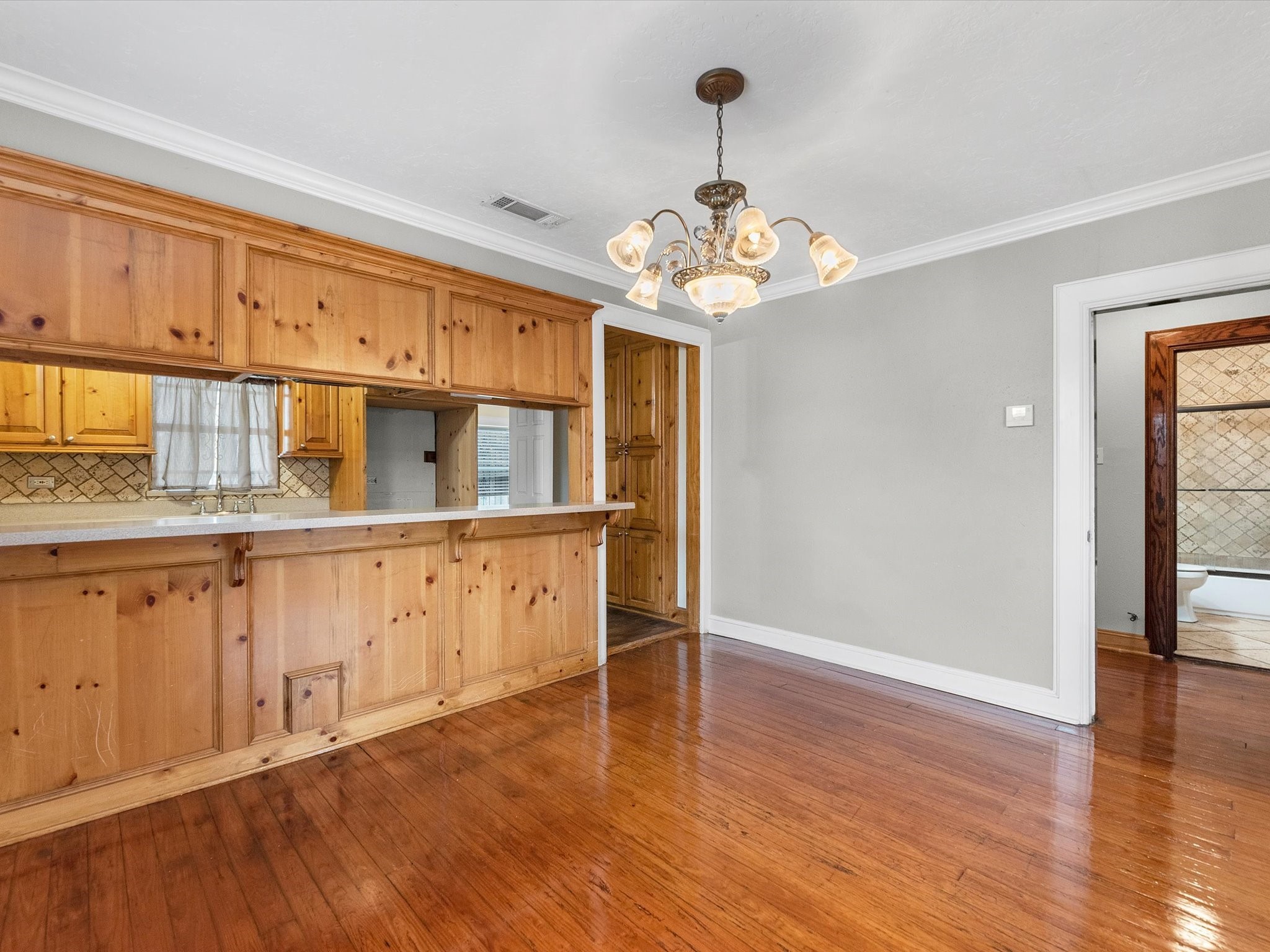 1211 Bigelow Street Houston, TX 77009 - Photo 5 of 18 a view of a kitchen with a dishwasher cabinets and wooden floor