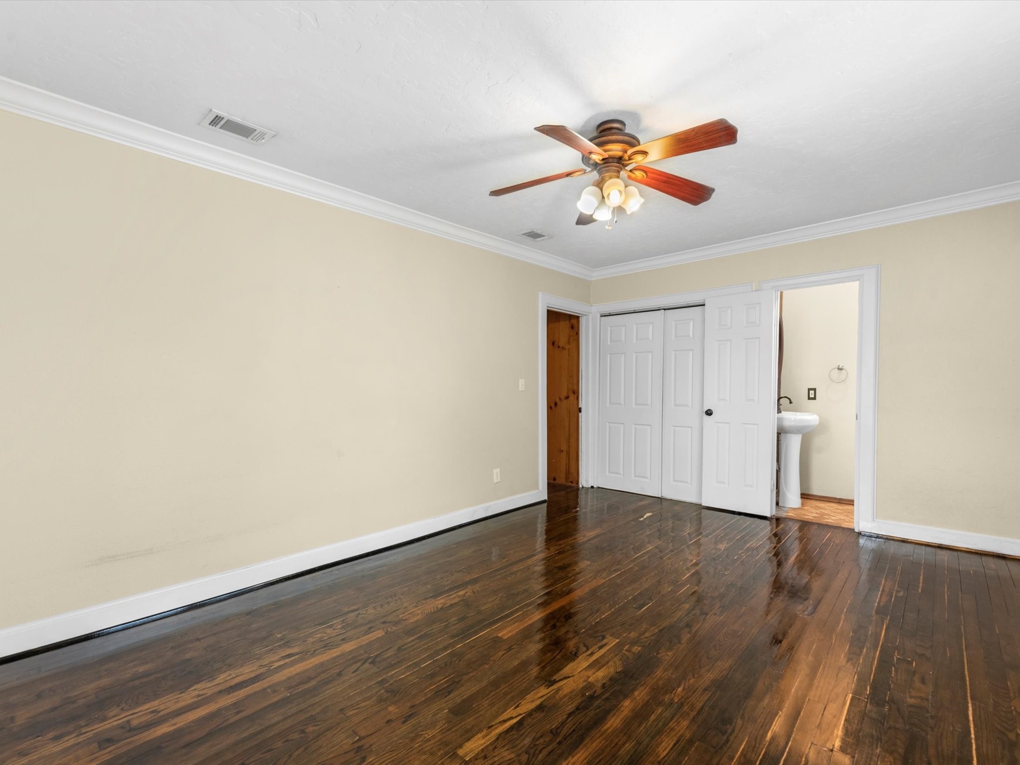 1211 Bigelow Street Houston, TX 77009 - Photo 9 of 18 a view of a room with wooden floor and a ceiling fan