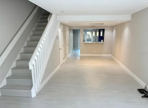 a view of entryway and hall with wooden floor