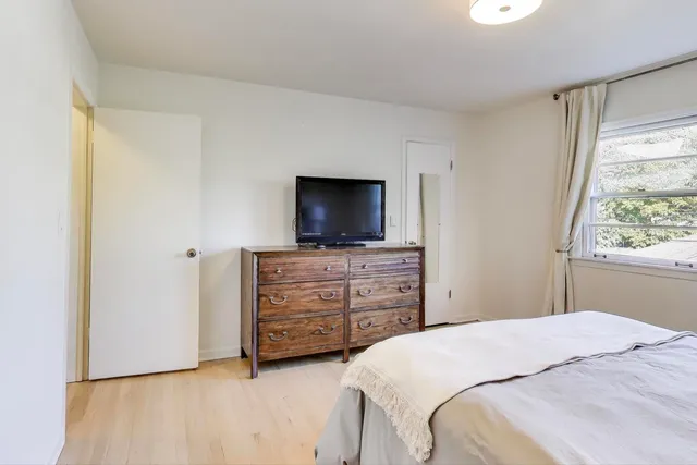 a bedroom with a bed and flat screen tv