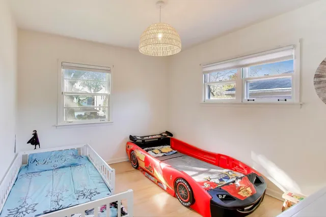 a bedroom with bed and a window