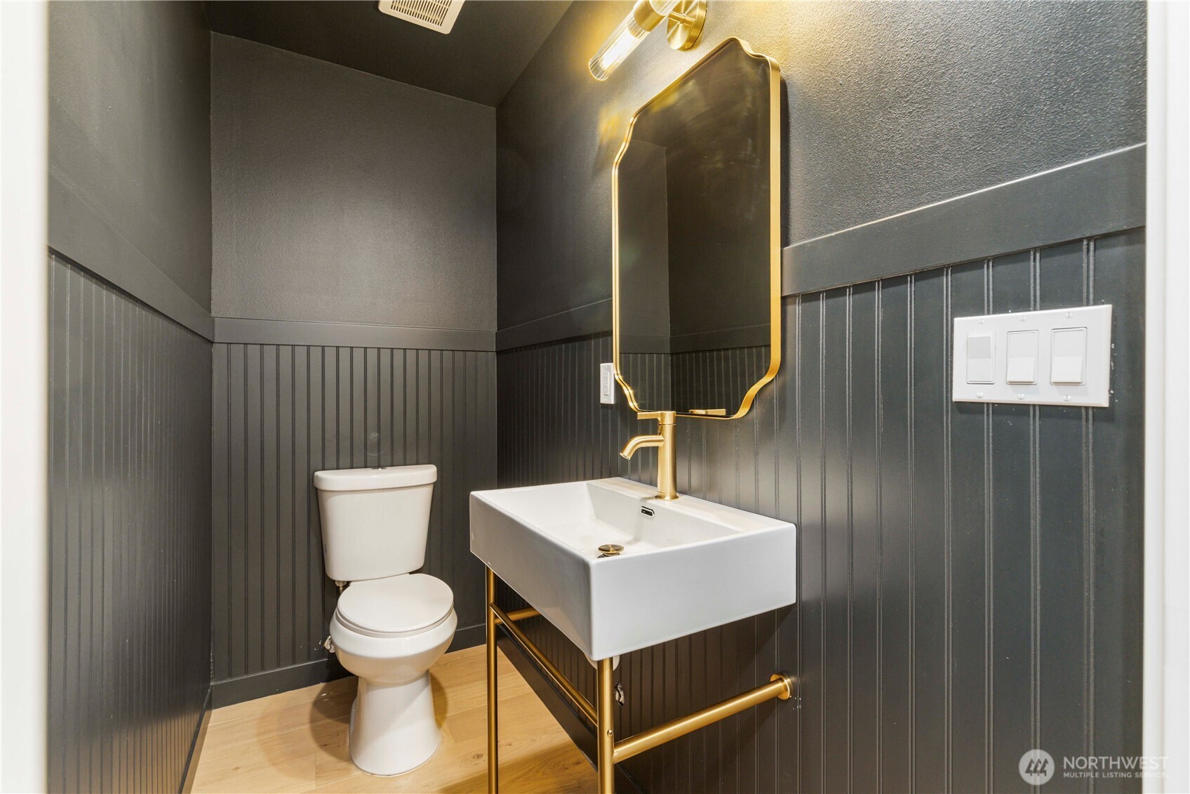 828 Northeast 95th Street Seattle, WA 98115 - Photo 7 of 18 a bathroom with a toilet sink and mirror