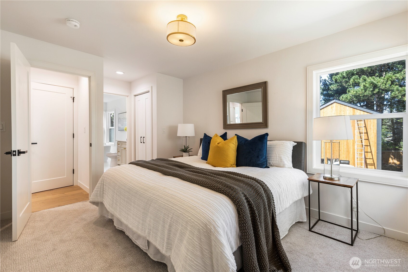 828 Northeast 95th Street Seattle, WA 98115 - Photo 9 of 18 a bedroom with a bed and a large window