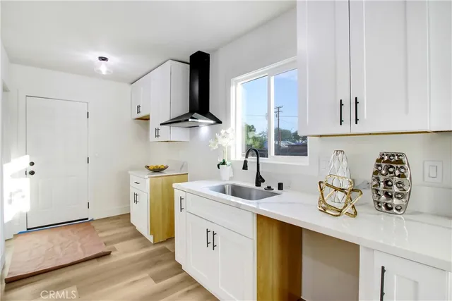 a kitchen with sink and cabinets
