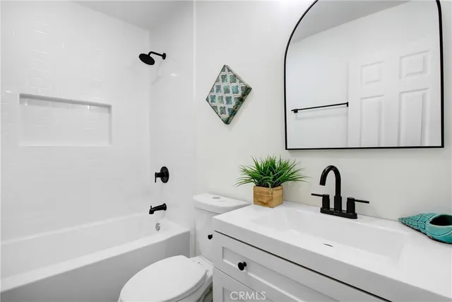 a bathroom with a sink a toilet and bathtub