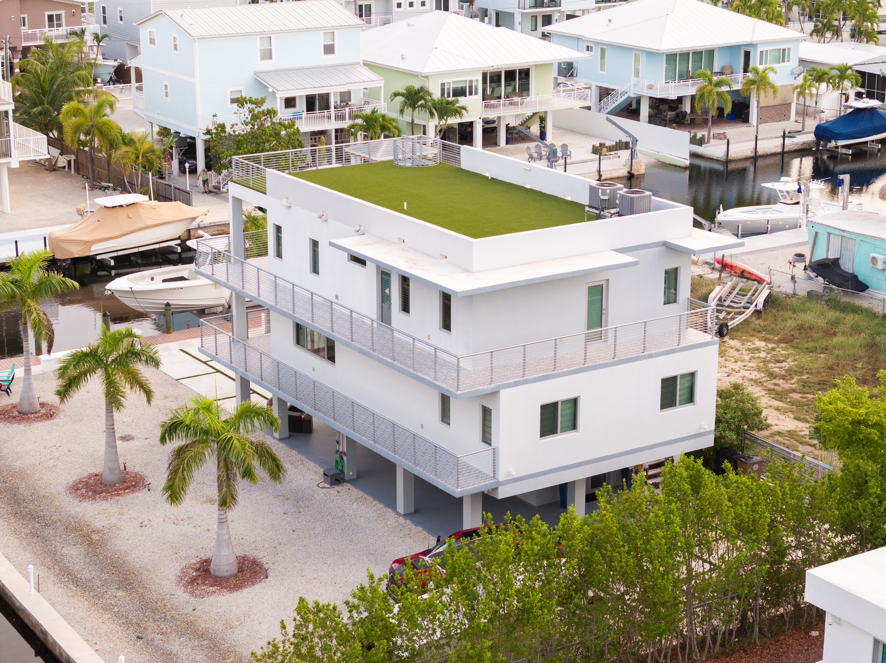 475 Bahia Honda Road Key Largo, FL 33037 - Photo 13 of 134 a view of a swimming pool with lawn chairs under an umbrella