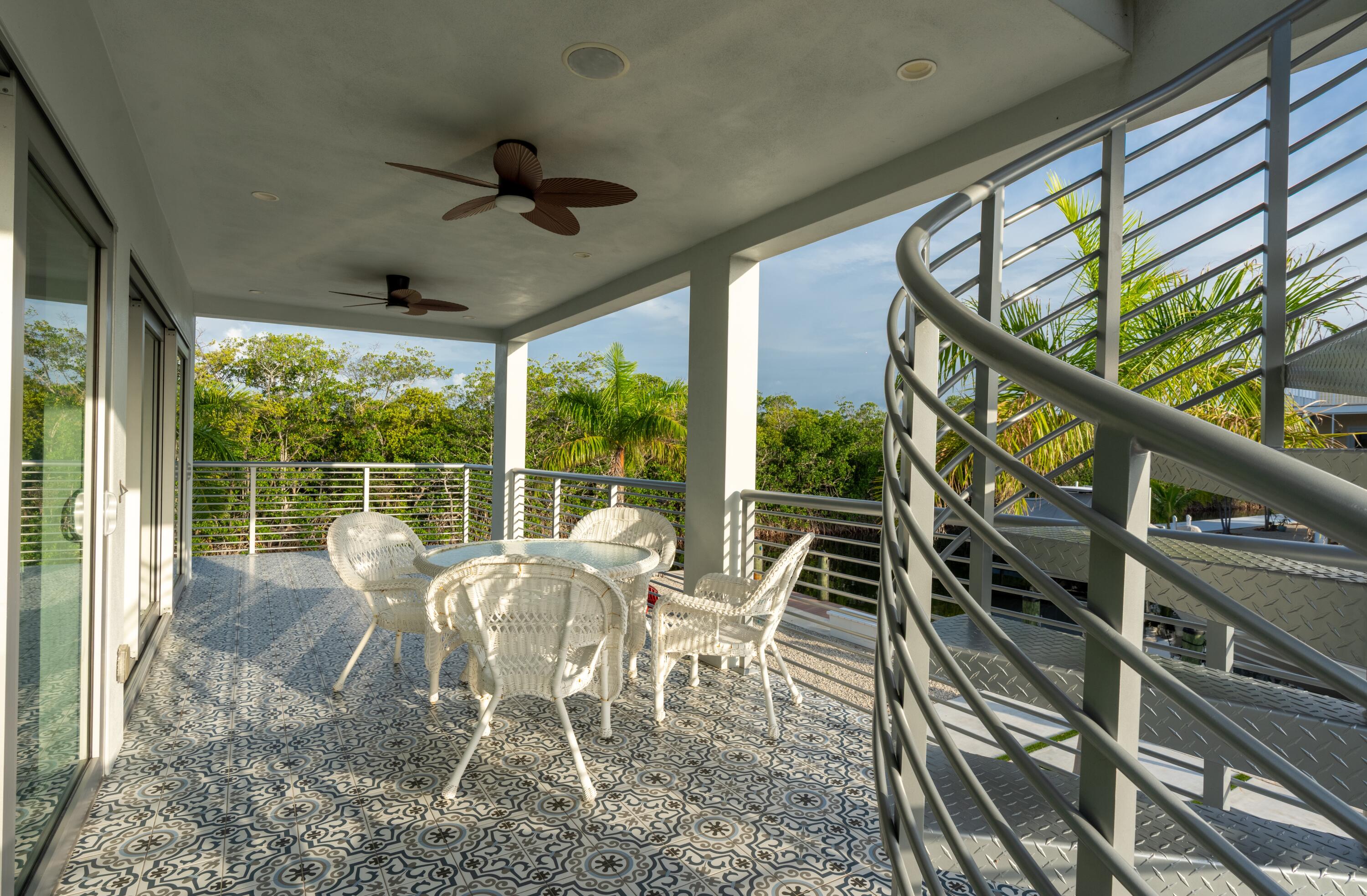 475 Bahia Honda Road Key Largo, FL 33037 - Photo 49 of 134 a view of a porch with furniture and wooden floor