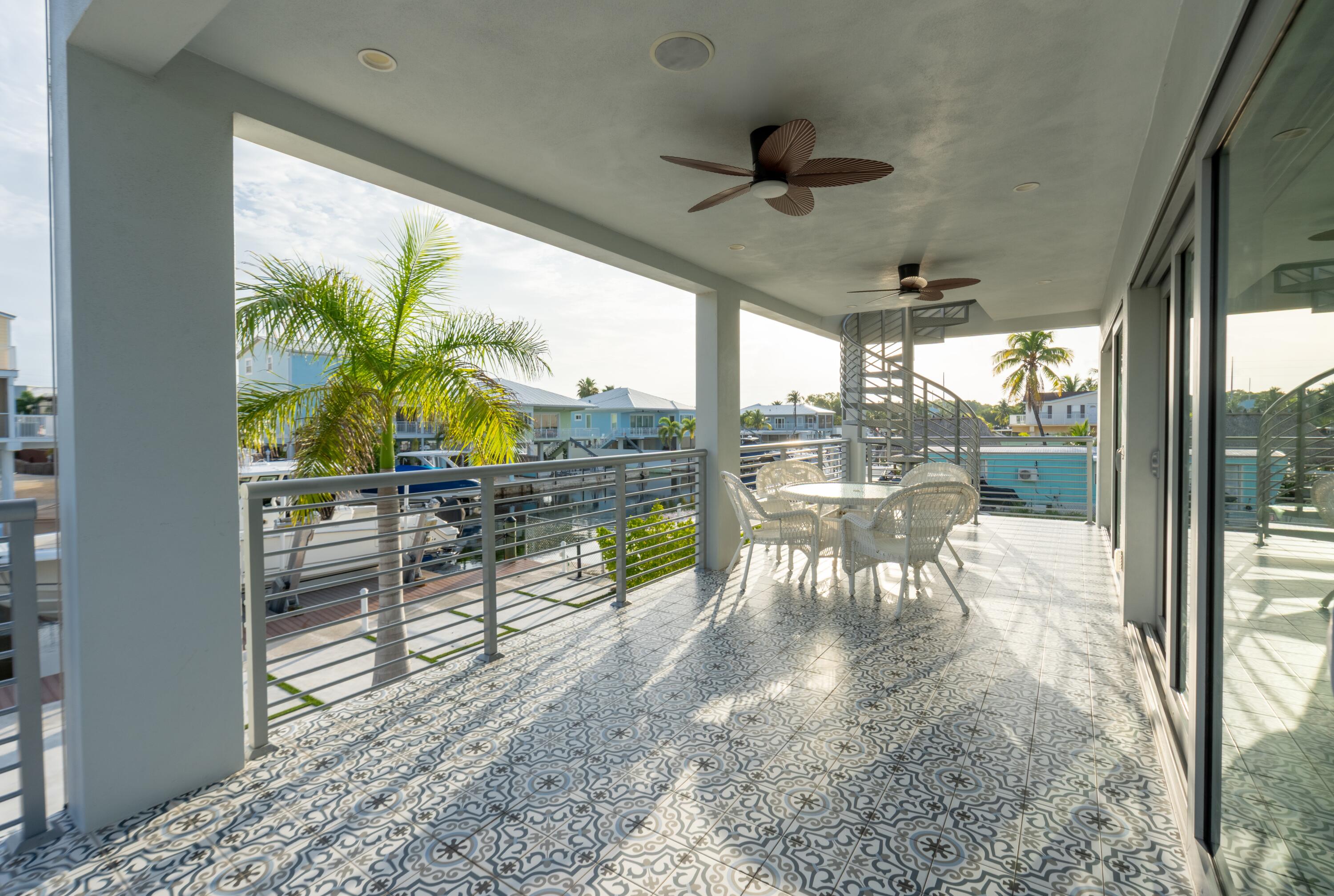 475 Bahia Honda Road Key Largo, FL 33037 - Photo 52 of 134 a view of a porch with chairs and backyard