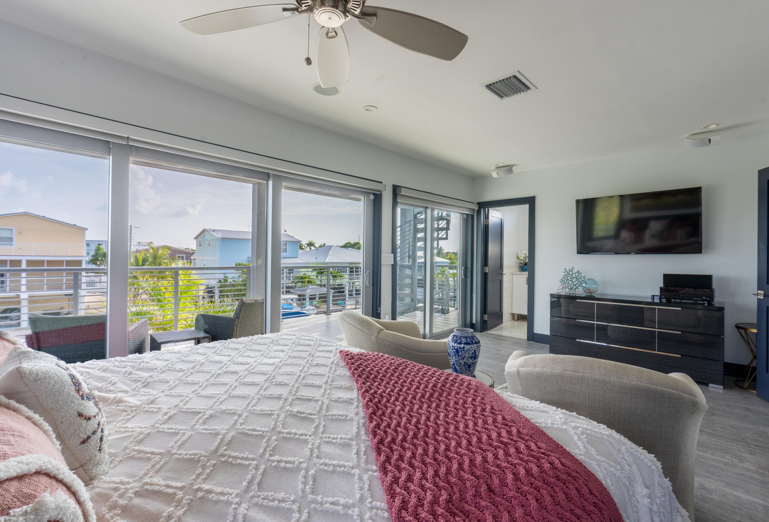 475 Bahia Honda Road Key Largo, FL 33037 - Photo 59 of 134 a bedroom with a bed and large windows
