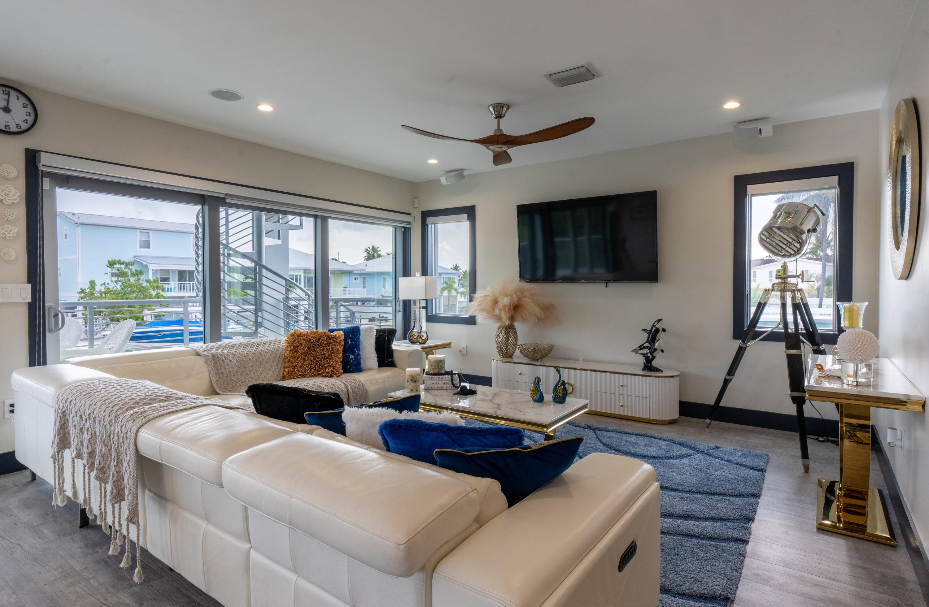 475 Bahia Honda Road Key Largo, FL 33037 - Photo 76 of 134 a living room with furniture floor to ceiling window hardwood floor and a flat screen tv