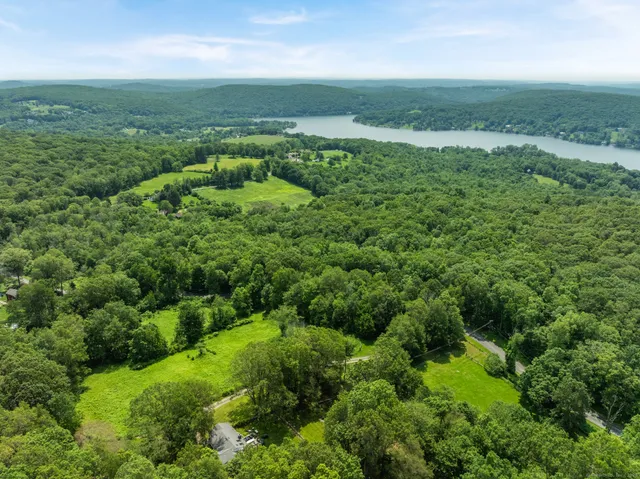 an aerial view of huge green field with lots of green space