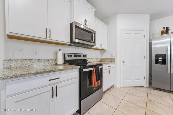 a kitchen with granite countertop cabinets and stainless steel appliances
