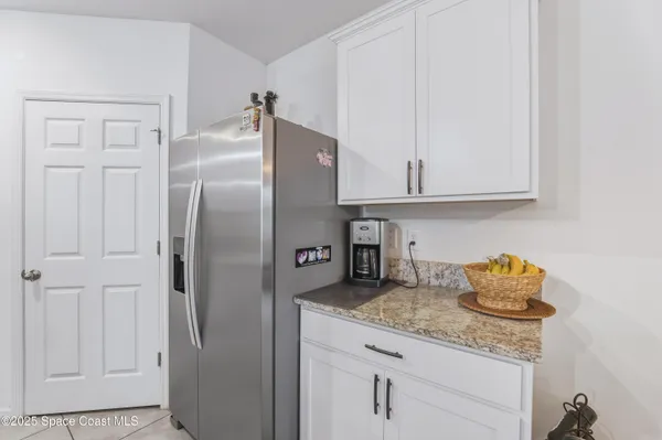 a kitchen with stainless steel appliances granite countertop a sink and refrigerator
