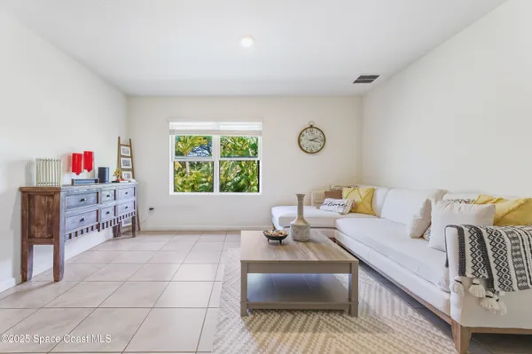 a living room with furniture a window and a table