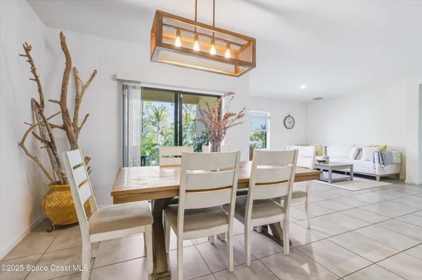 a dining room with furniture and a window