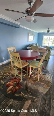 a patio with a table chairs and a chandelier