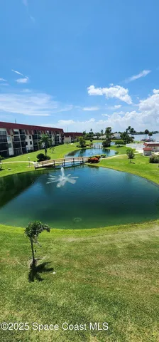 a view of a golf course with an ocean