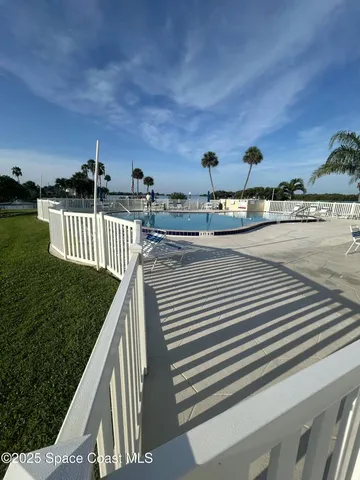 a view of a swimming pool with an outdoor seating and a residential buildings