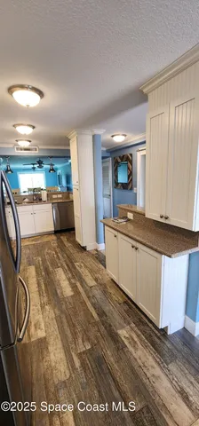 a kitchen with stainless steel appliances granite countertop a sink and cabinets