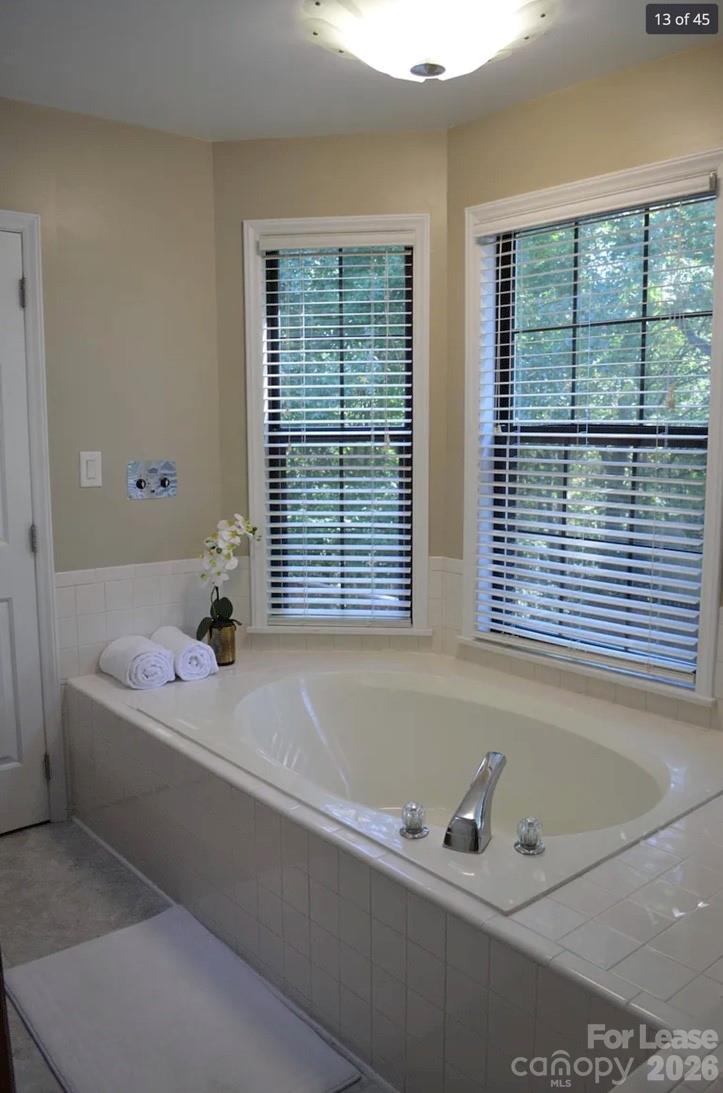 4167 Greenview Court Fort Mill, SC 29708 - Photo 8 of 16 a bath tub sitting in a bathroom next to a window