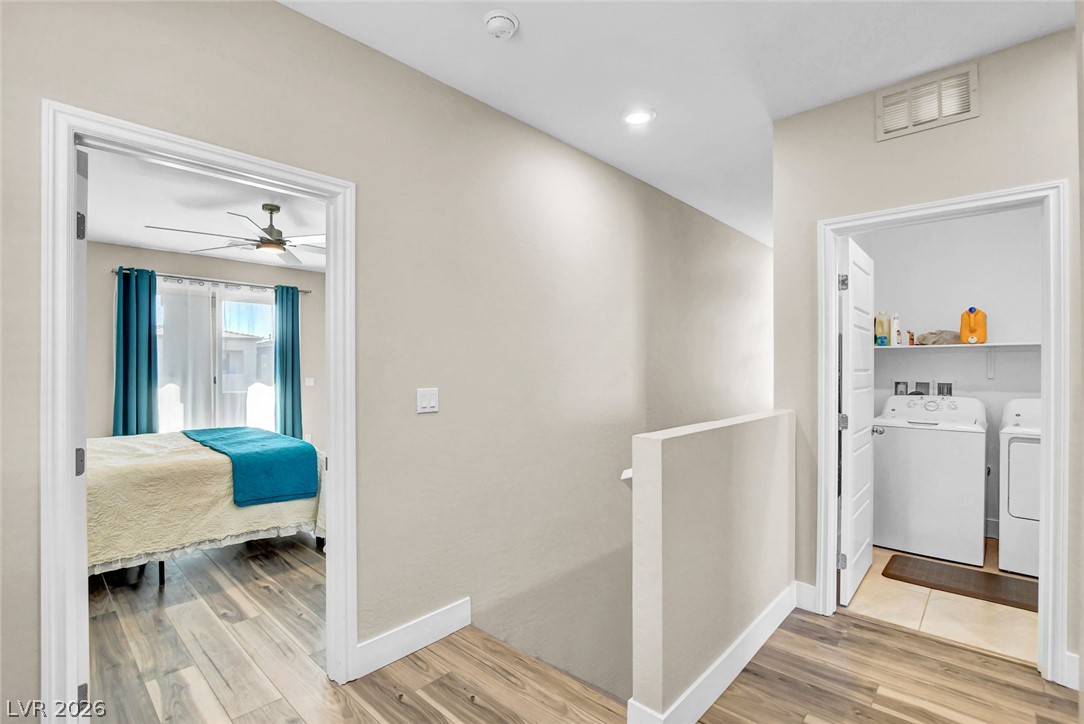 9688 Rankin Rdg Court Las Vegas, NV 89178 - Photo 22 of 53 Functional hallway with wood-look flooring connects a restful bedroom to a convenient laundry area.