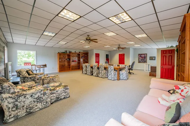 a living room with furniture and a chandelier