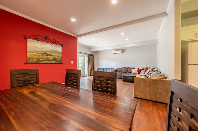 a bedroom with furniture and a flat screen tv