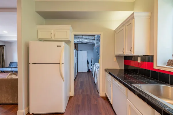 a kitchen with a refrigerator and a stove