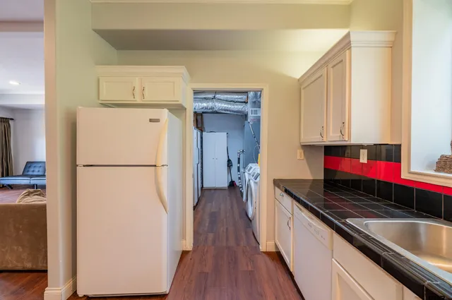 a kitchen with a refrigerator and a stove