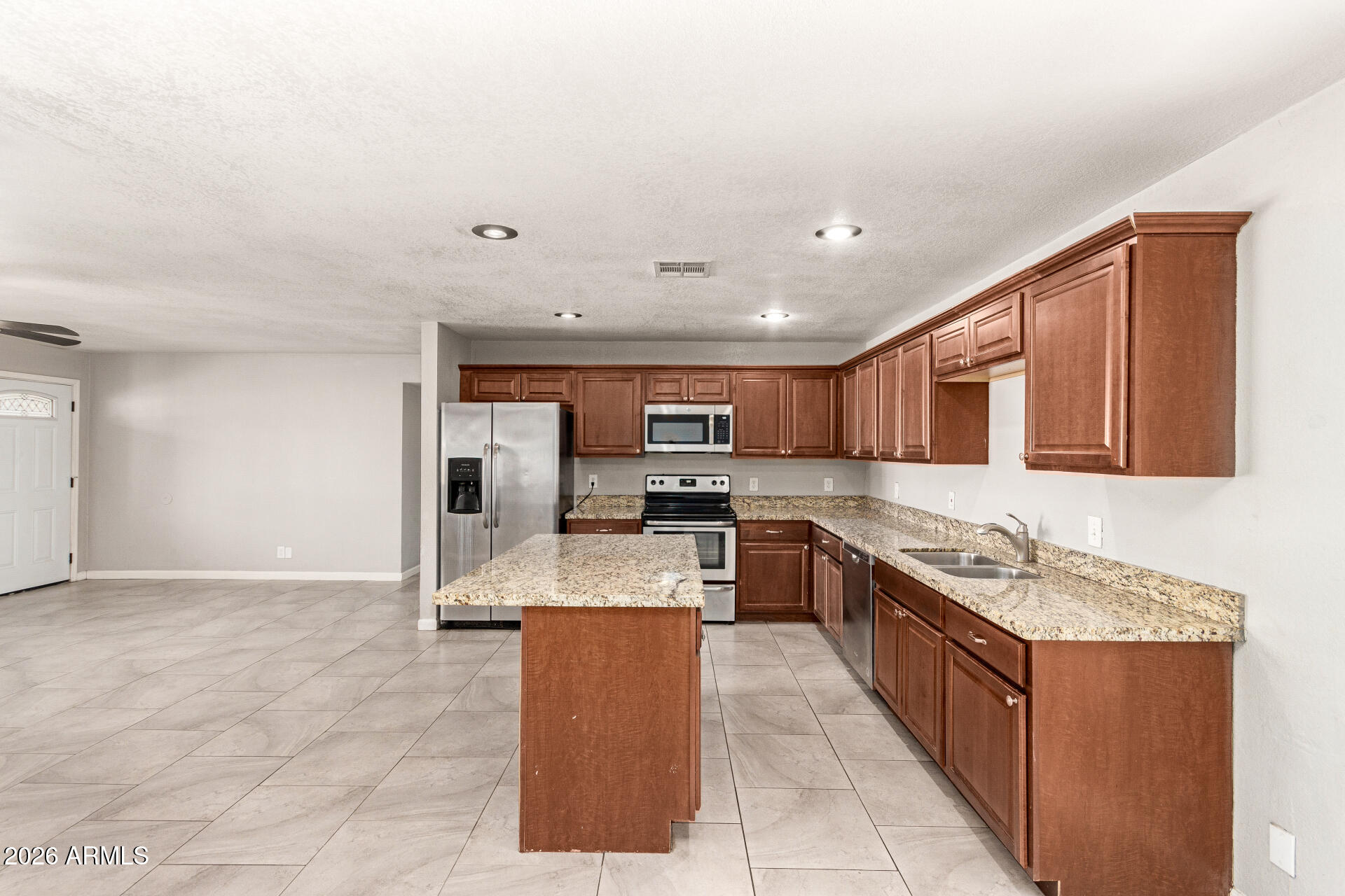 1708 North Daffodil Street Tempe, AZ 85288 - Photo 13 of 34 a large kitchen with stainless steel appliances granite countertop a large counter top and a stove