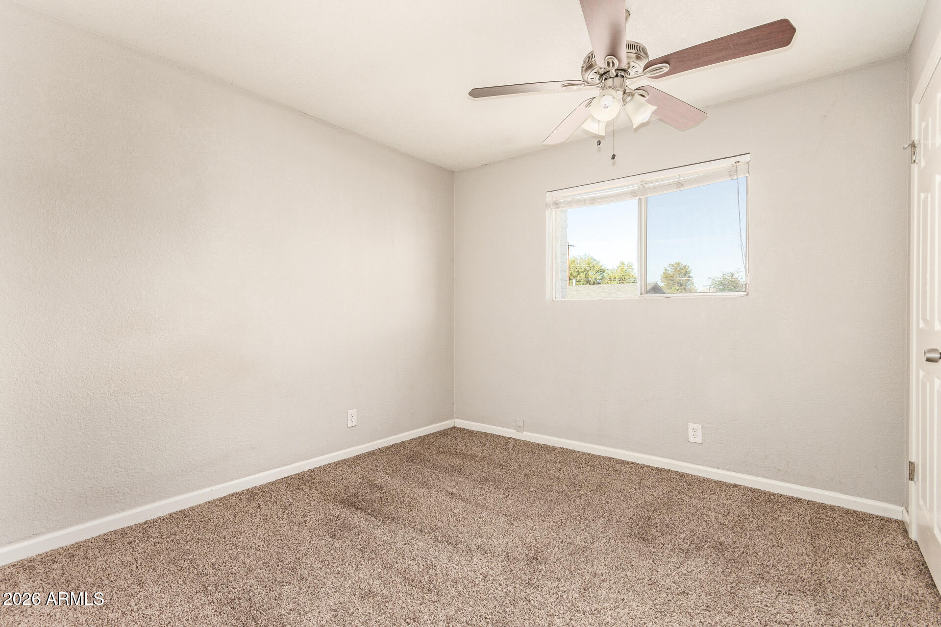1708 North Daffodil Street Tempe, AZ 85288 - Photo 21 of 34 an empty room with a window and a fan