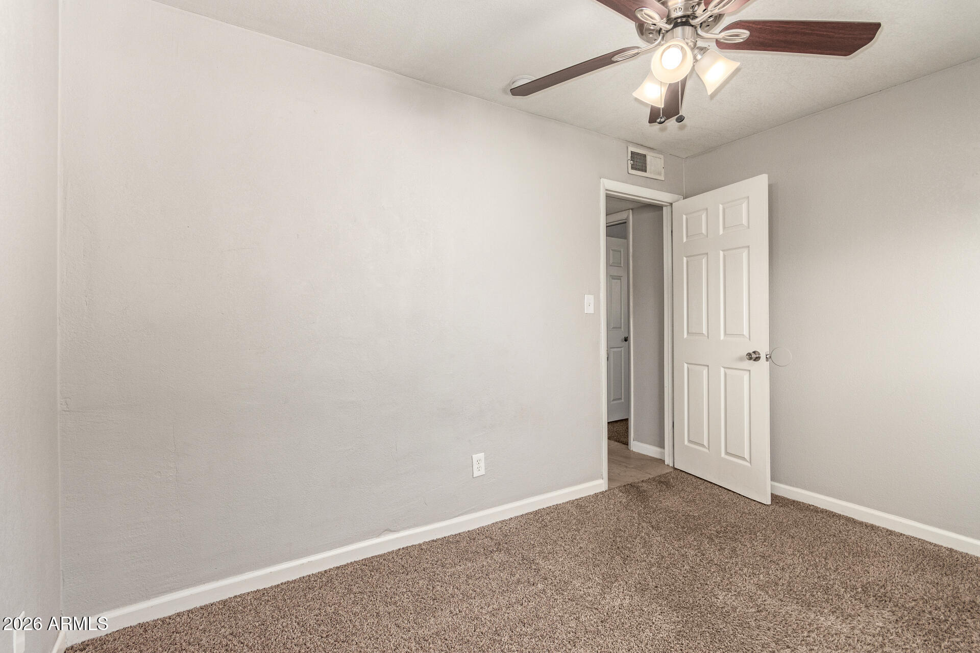 1708 North Daffodil Street Tempe, AZ 85288 - Photo 27 of 34 an empty room with a chandelier fan