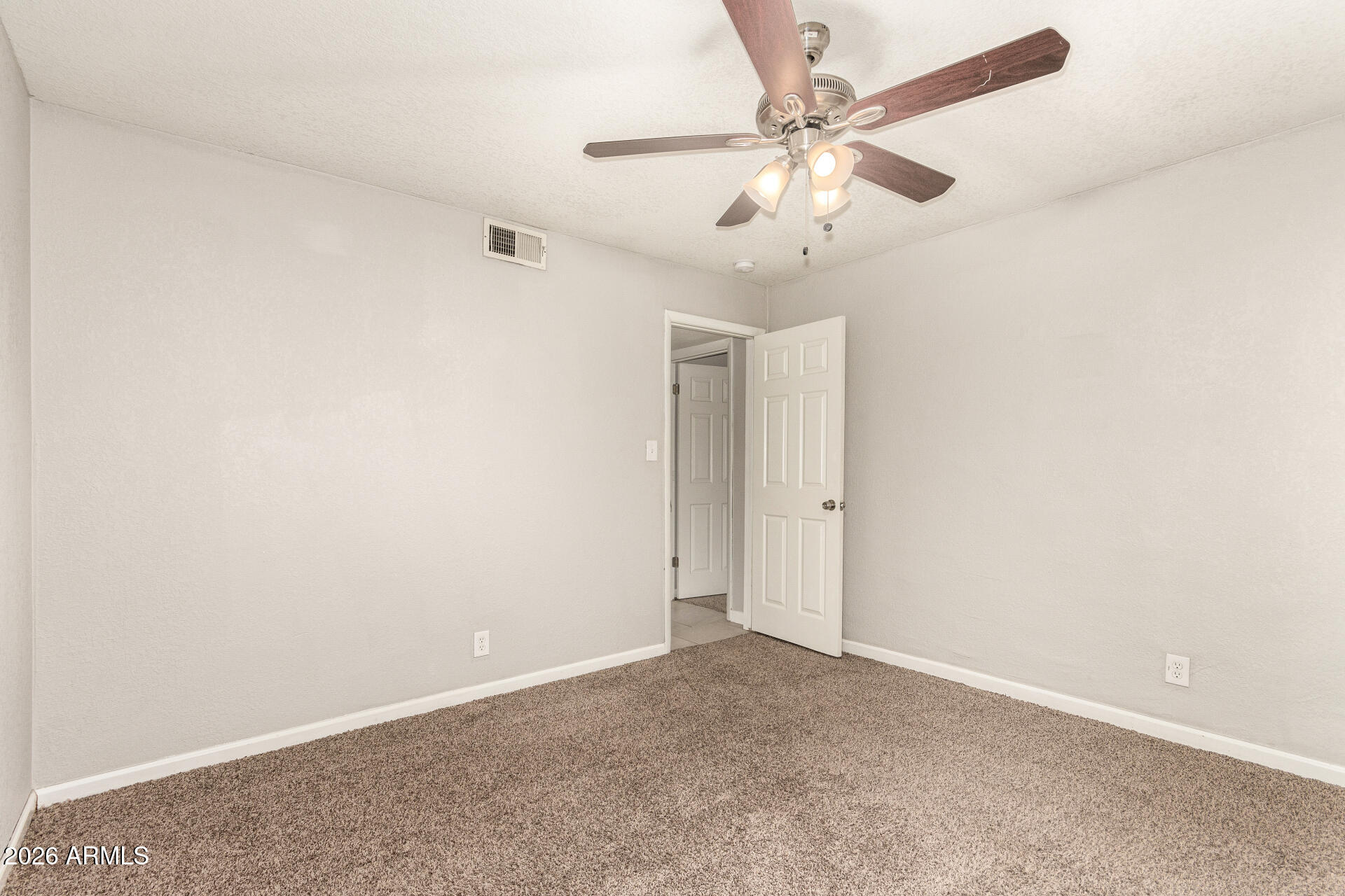 1708 North Daffodil Street Tempe, AZ 85288 - Photo 29 of 34 an empty room with a chandelier fan and windows