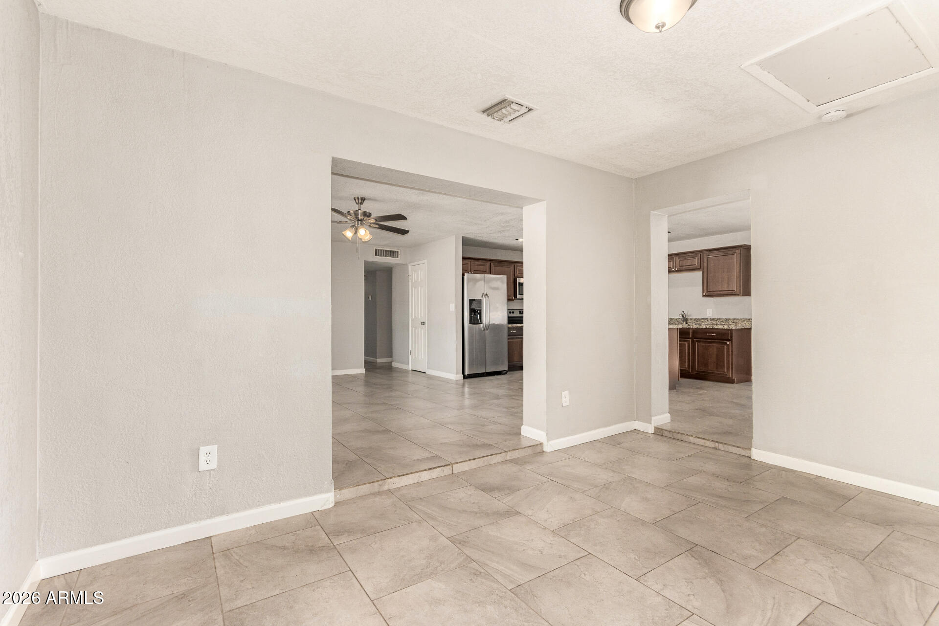 1708 North Daffodil Street Tempe, AZ 85288 - Photo 7 of 34 an empty room & kitchen space with closet