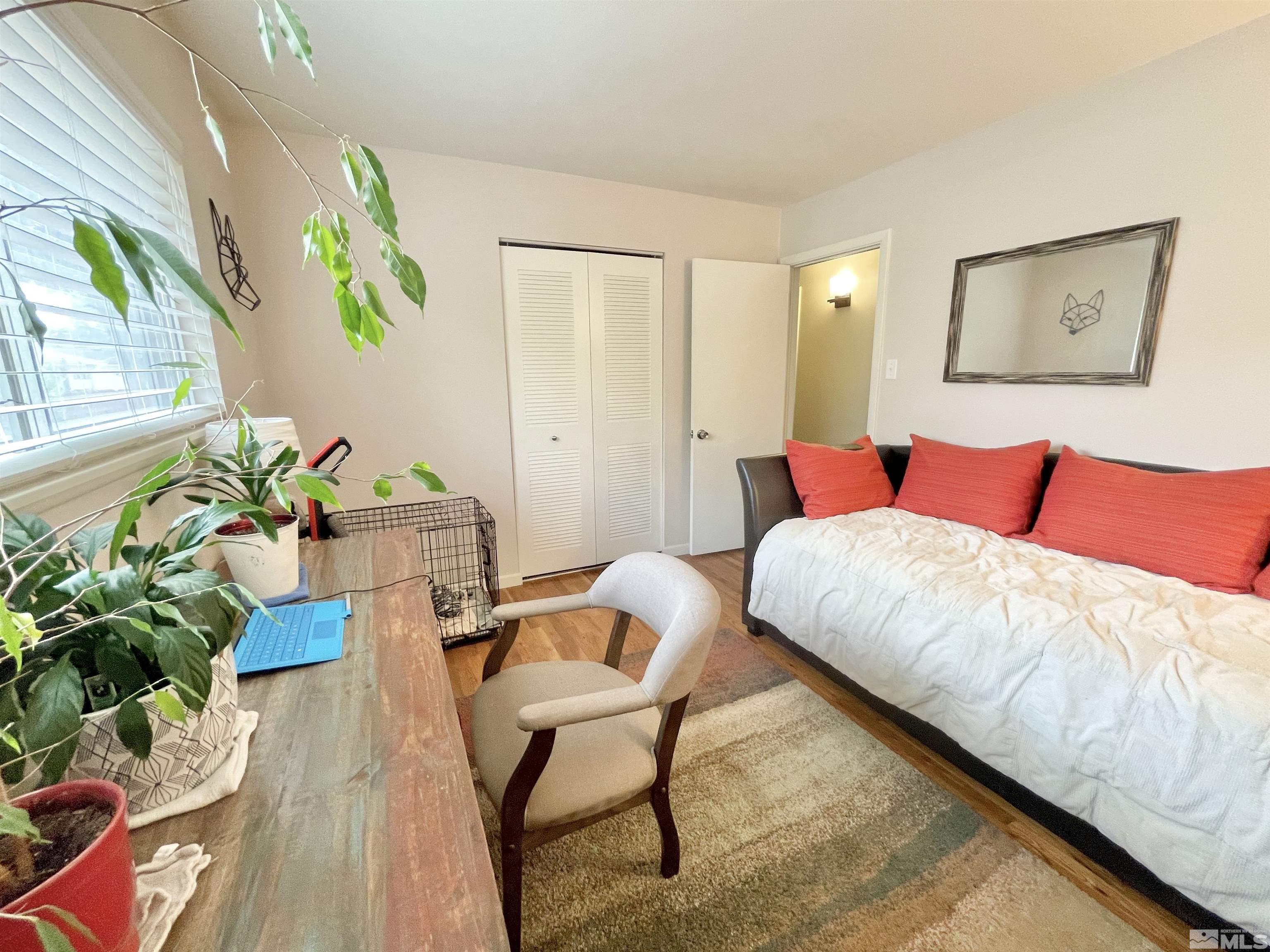 3230 Sandra Drive Reno, NV 89503 - Photo 12 of 25 a bedroom with a bed potted plant and a window
