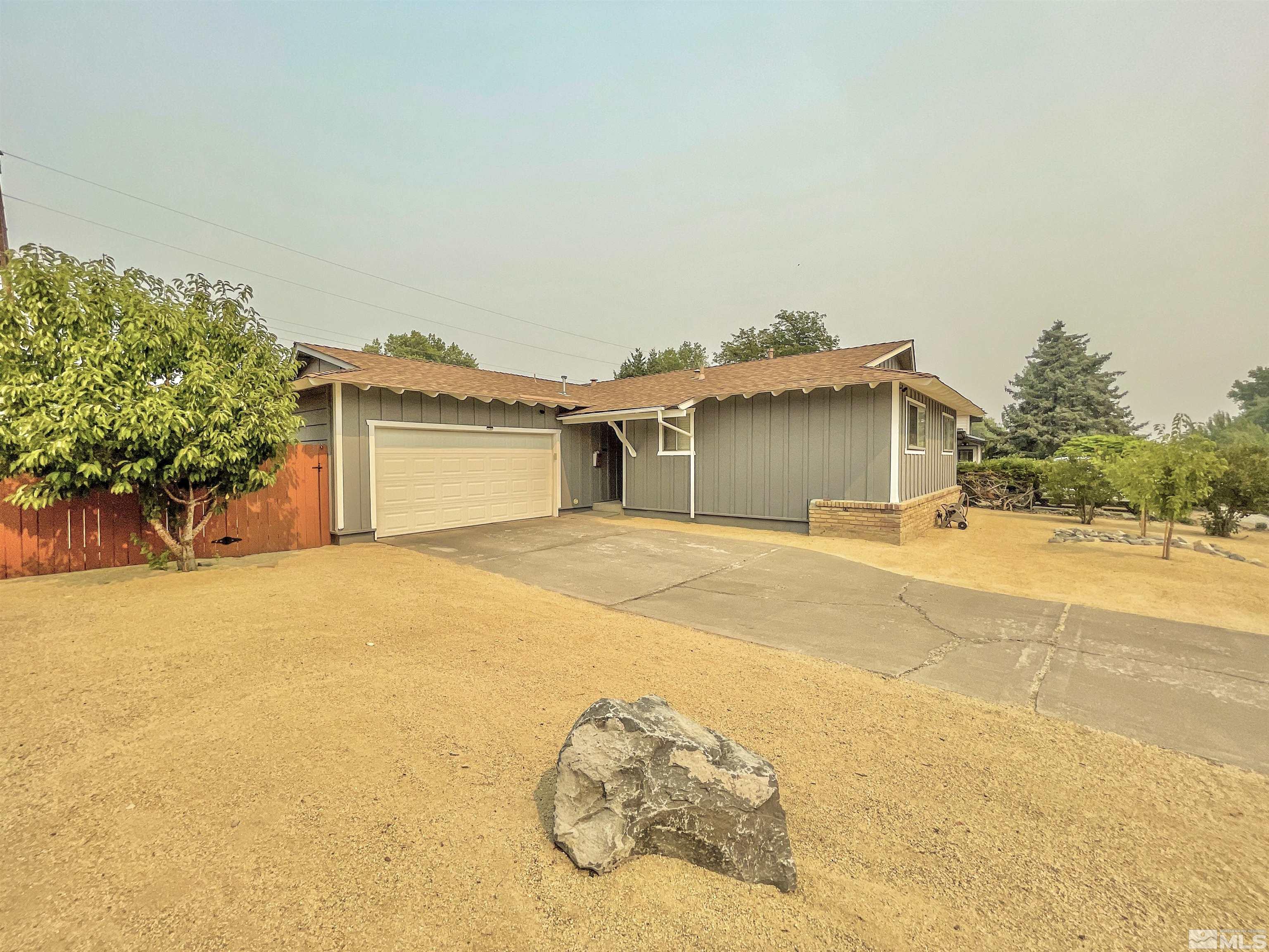 3230 Sandra Drive Reno, NV 89503 - Photo 2 of 25 a front view of a house with a yard and garage