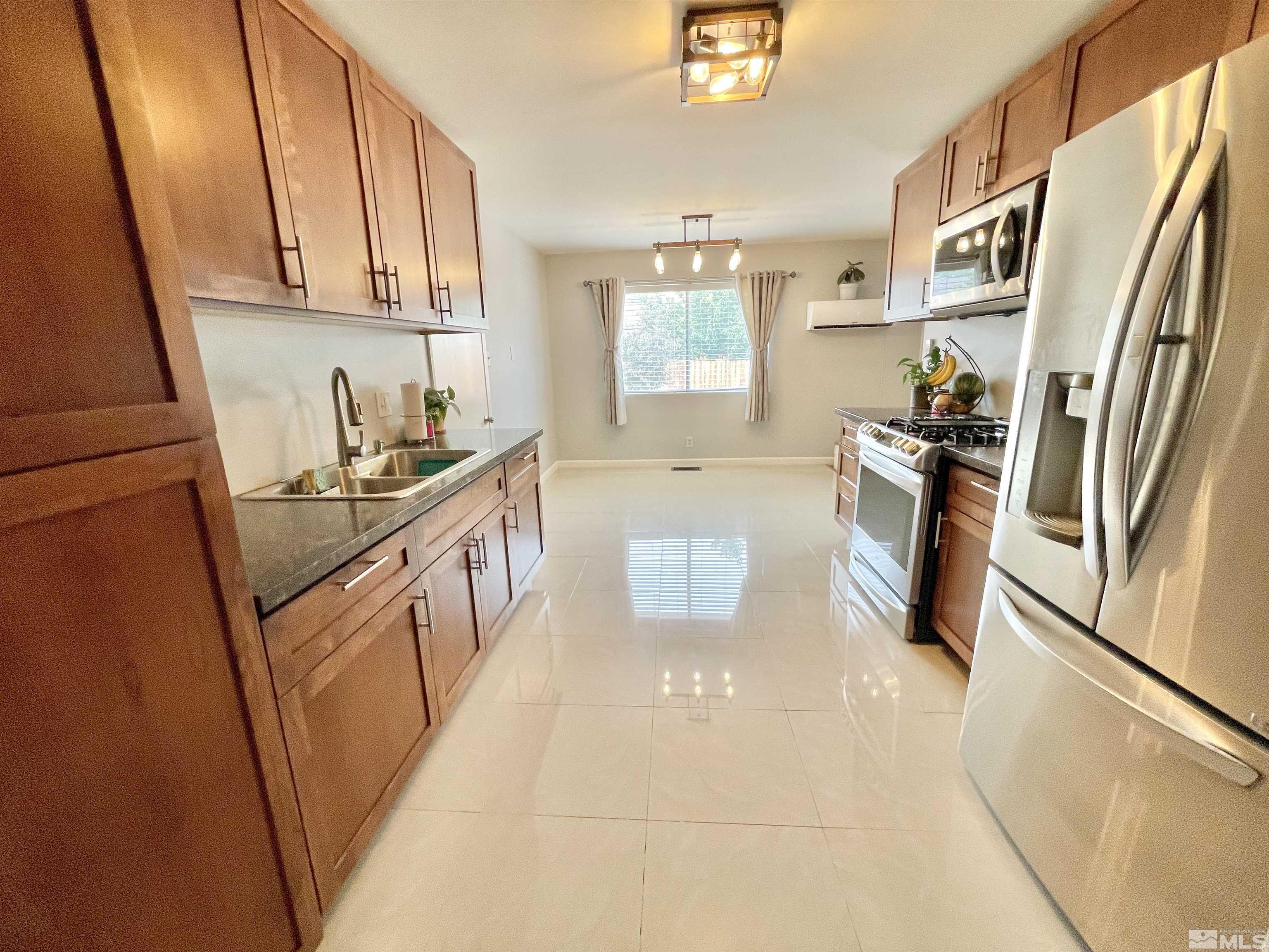 3230 Sandra Drive Reno, NV 89503 - Photo 4 of 25 a kitchen with stainless steel appliances granite countertop a refrigerator a stove a sink and dishwasher