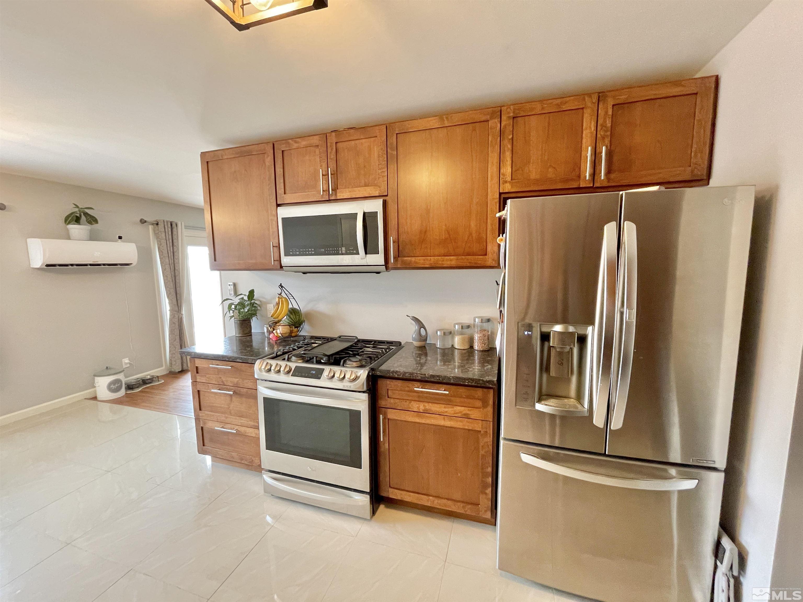 3230 Sandra Drive Reno, NV 89503 - Photo 6 of 25 a kitchen with stainless steel appliances granite countertop a refrigerator stove a sink and dishwasher