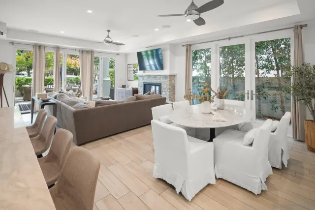 a living room with furniture a large window and a fireplace